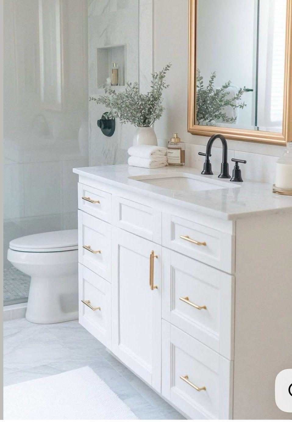 Finished powder room in marble with brass fixtures and a custom vanity