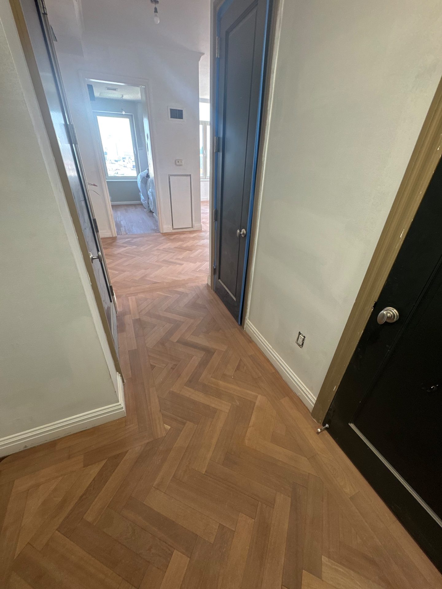 Herringbone hardwood in a sunlit hallway