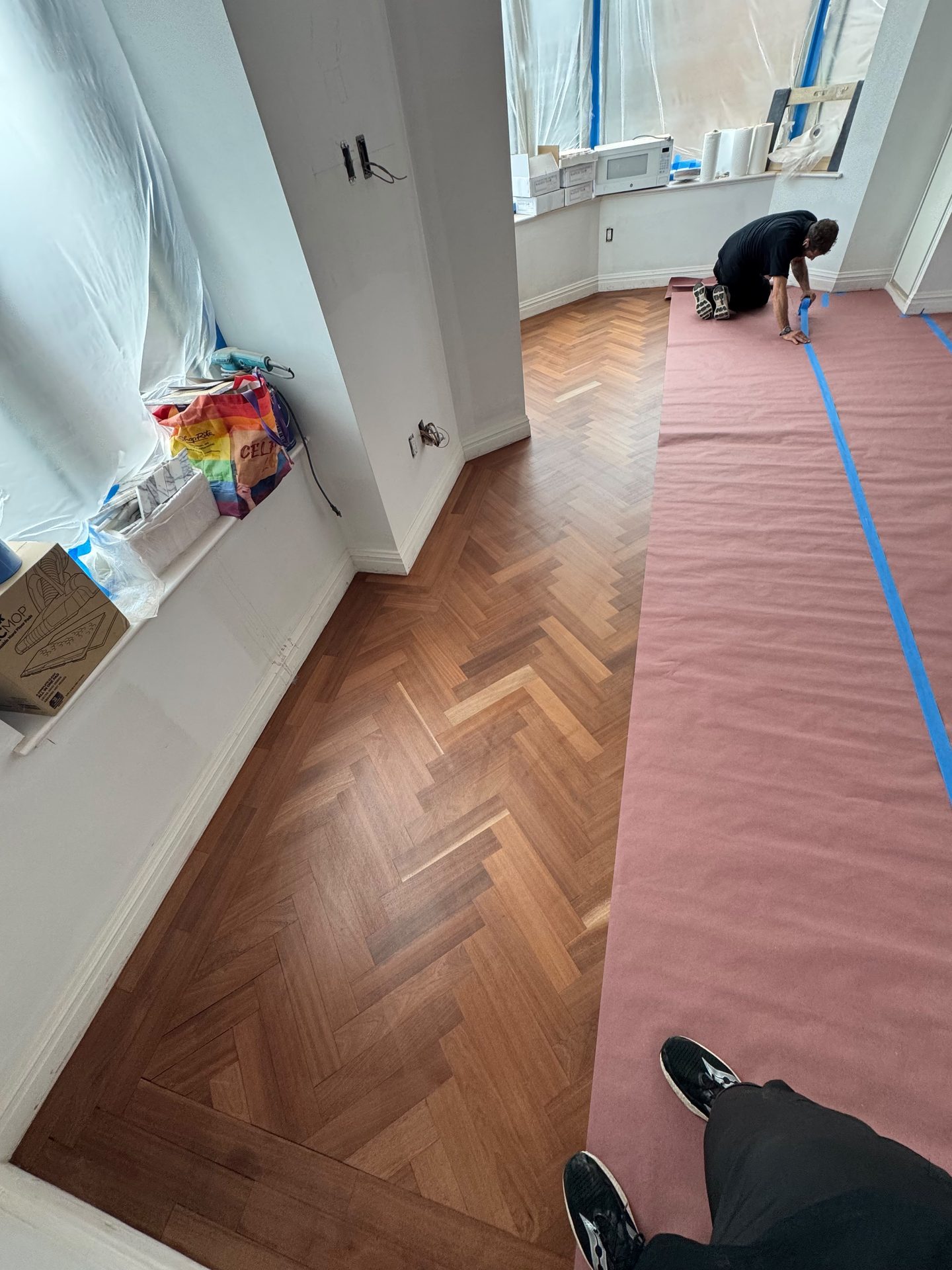 Herringbone flooring during a full apartment renovation