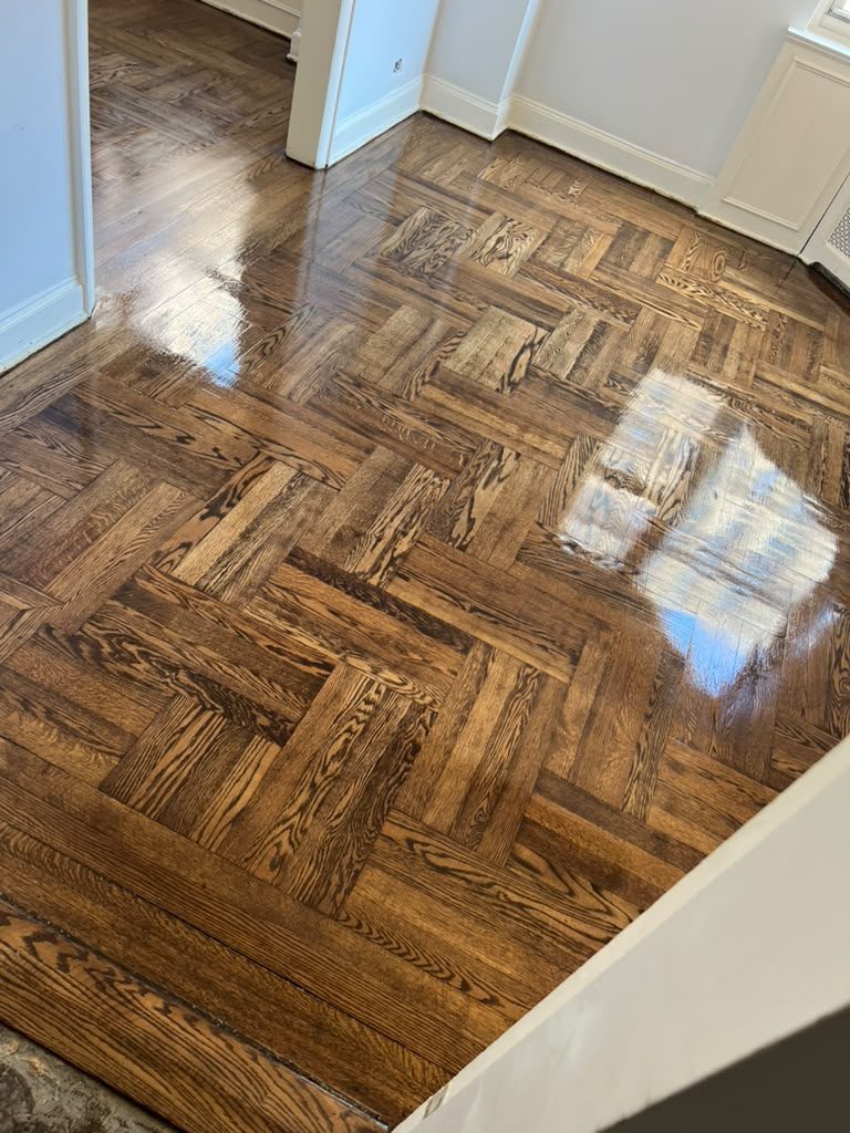Close detail of custom basket-weave parquet with a high-gloss finish