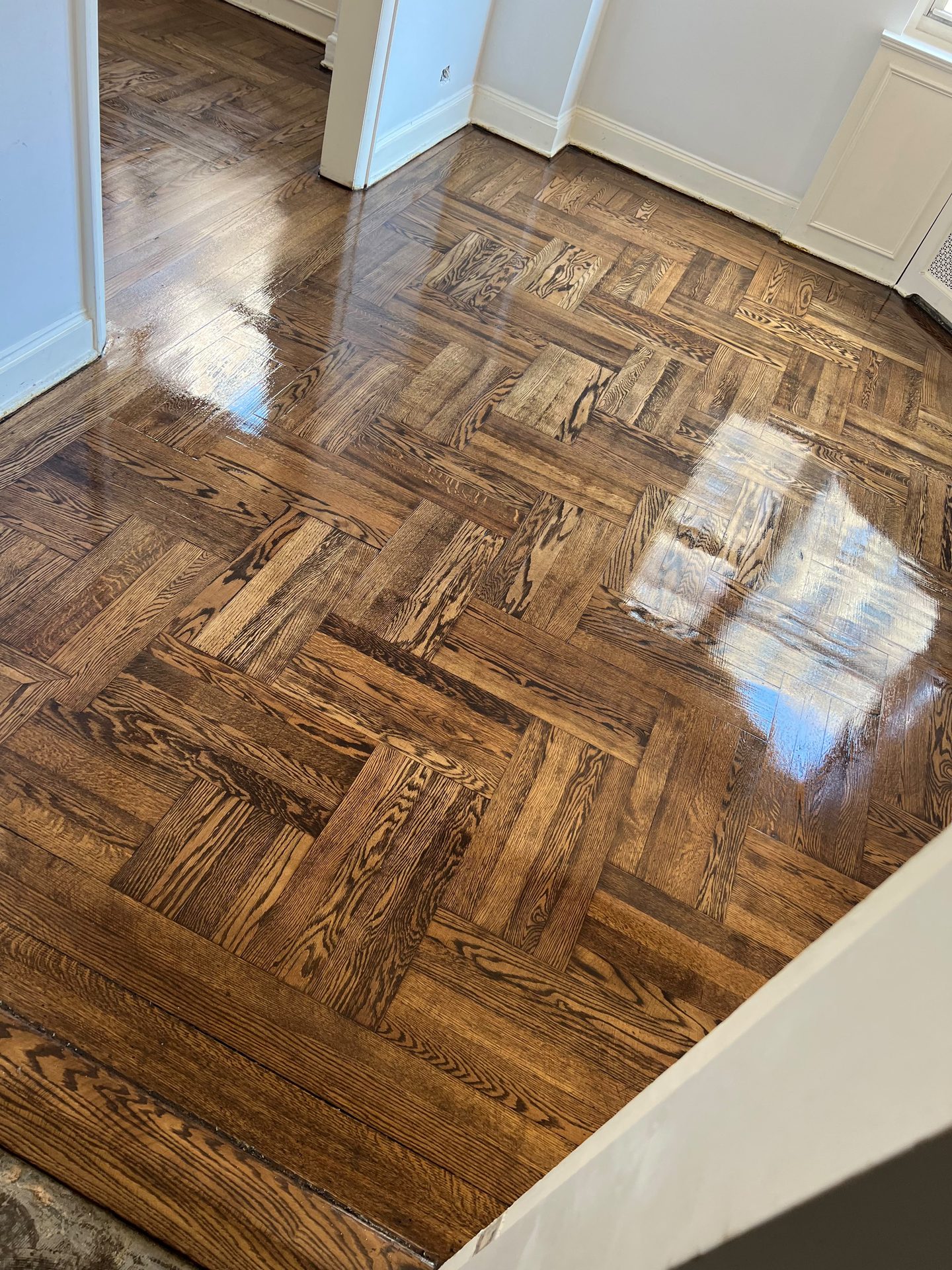 Warm-toned parquet flooring, freshly sealed