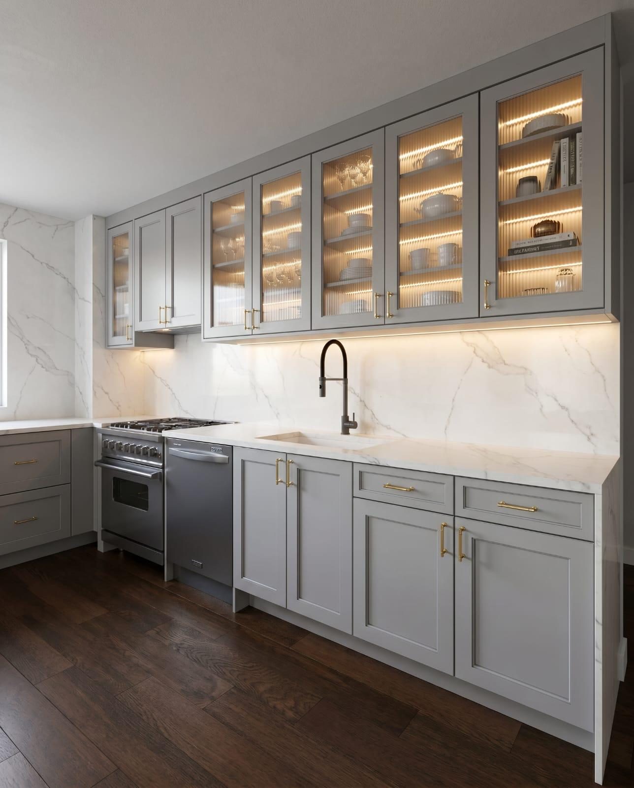 Custom kitchen with marble counters and illuminated glass display cabinets