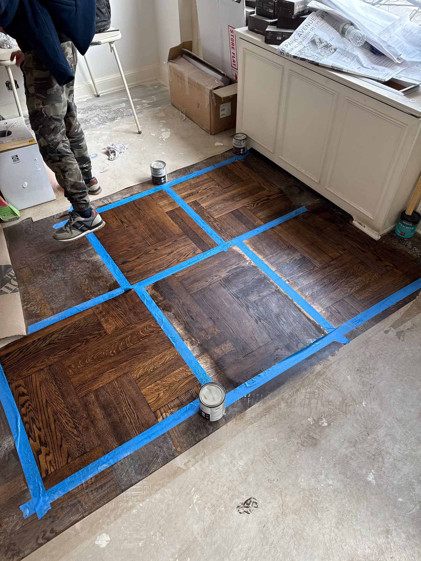 Hardwood floor refinishing with a taped layout