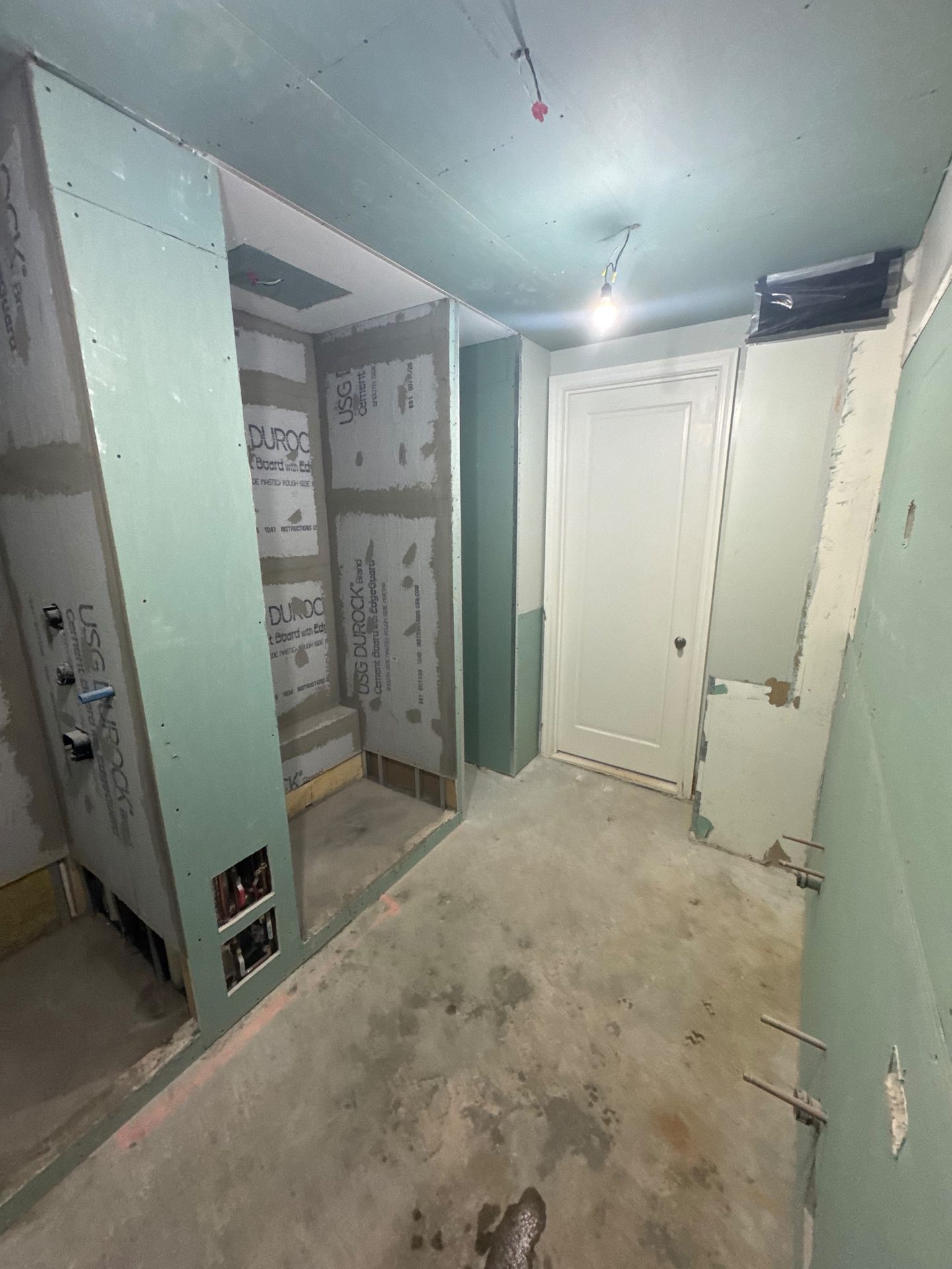 Fresh plaster and prime coat during a hallway renovation